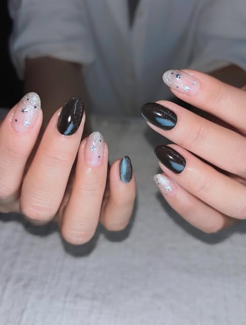 Celestial glitter tips mixed with blue cat-eye gel.